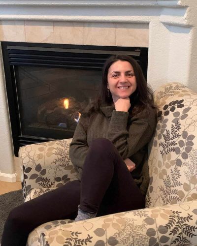 Nikki Resting in front of a Fireplace
